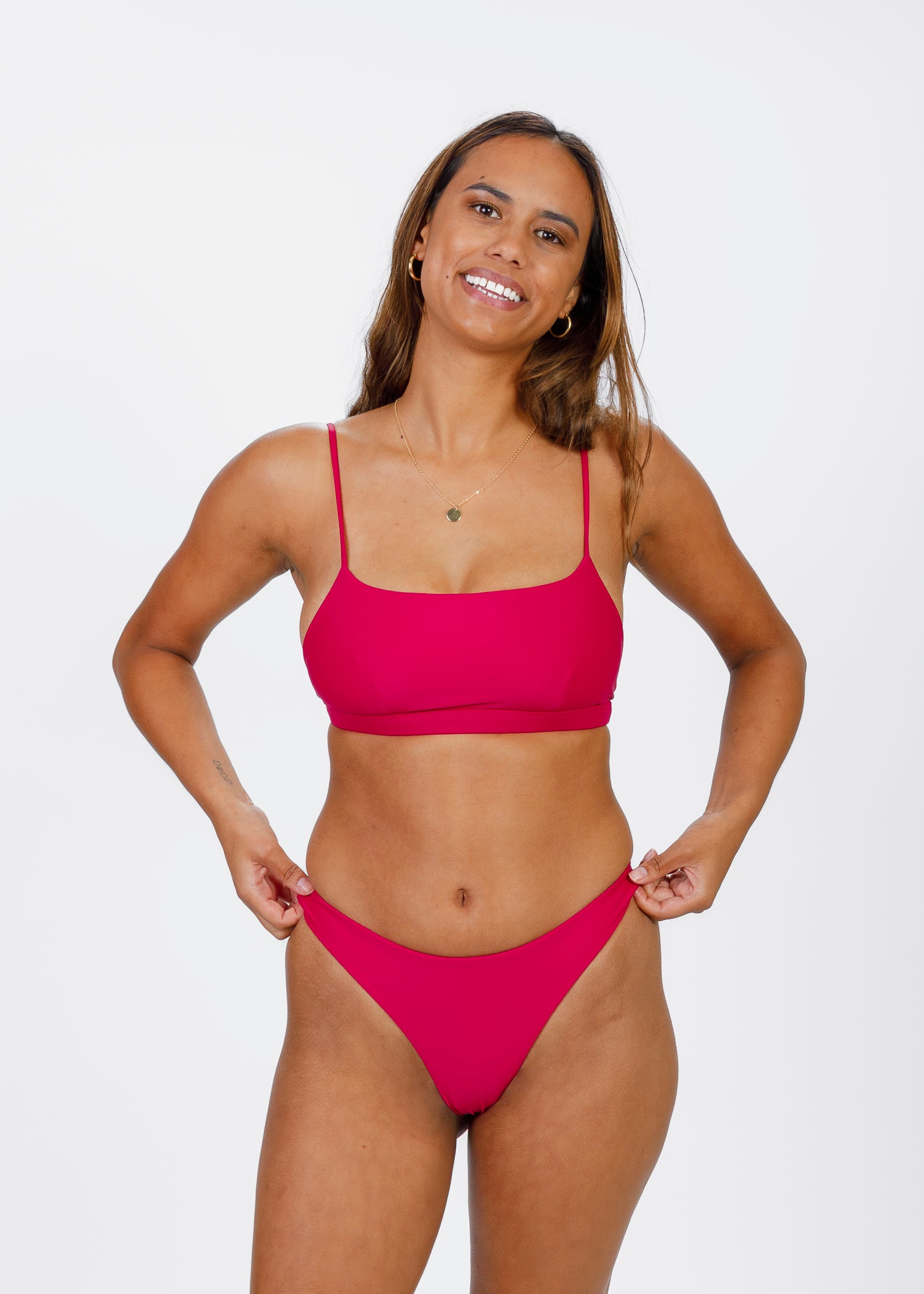 Close-up of a woman wearing a pink square-neck bikini top from Tamara, highlighting its flattering, supportive fit and sustainable design.